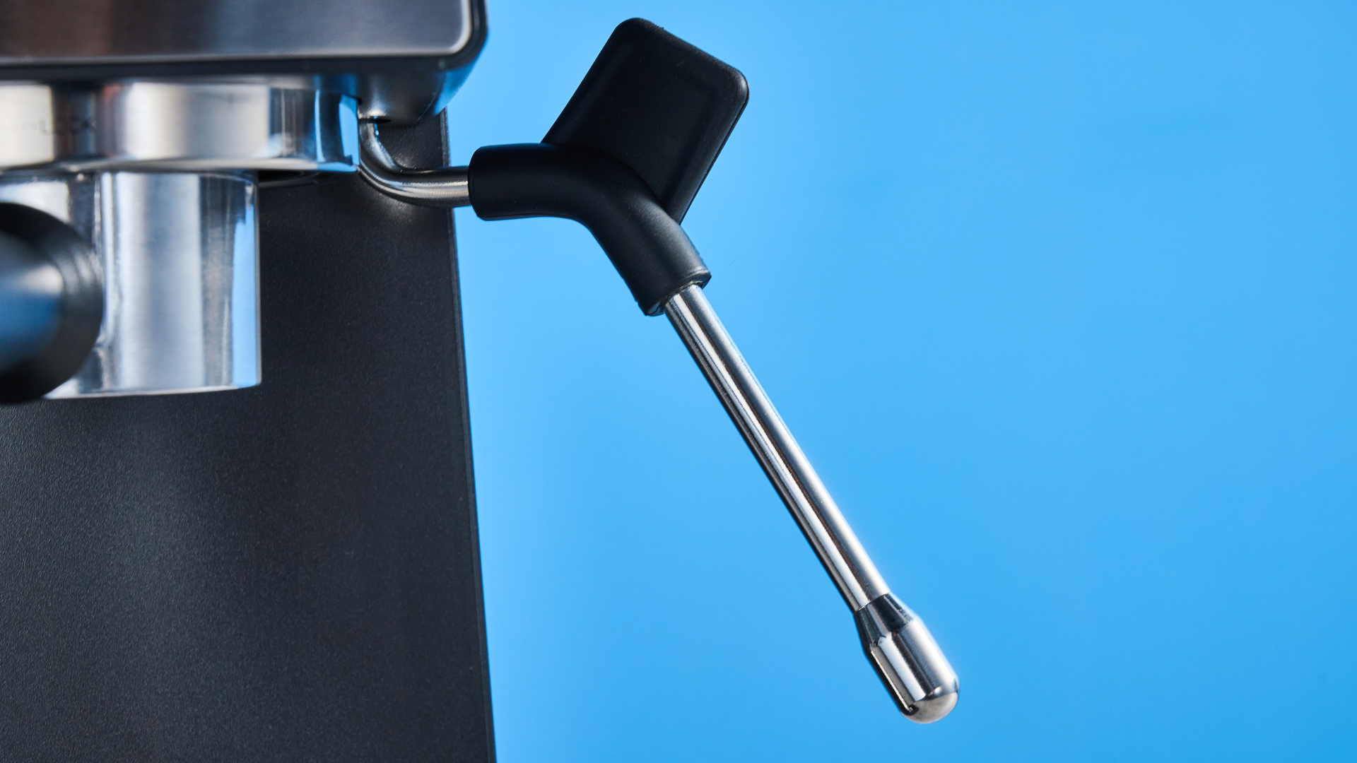 The Cuisinart Espresso Bar Slim espresso machine on a stone surface with a blue background