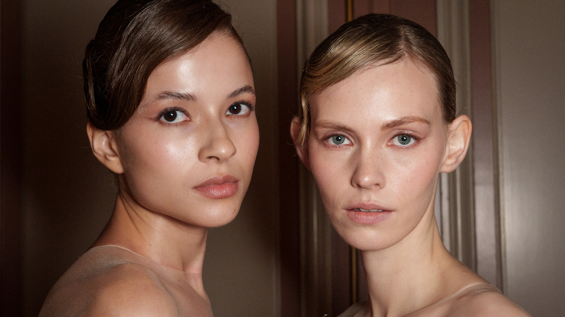 Two models with glowy skin backstage at ziad nakad spring 2025 show