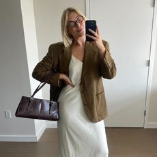 Editor Natalie Gray Herder Wearing White Slip Dress and Brown Suede Blazer