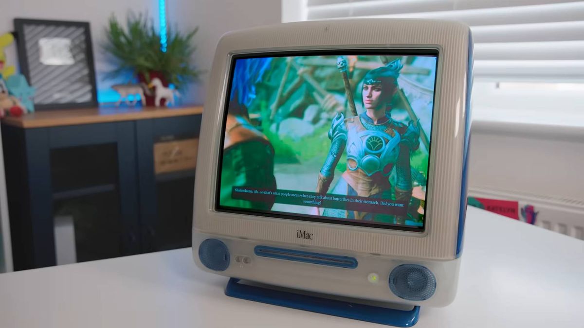 iMac G3 with Mac mini inside on white desk running Baldur's Gate 3.