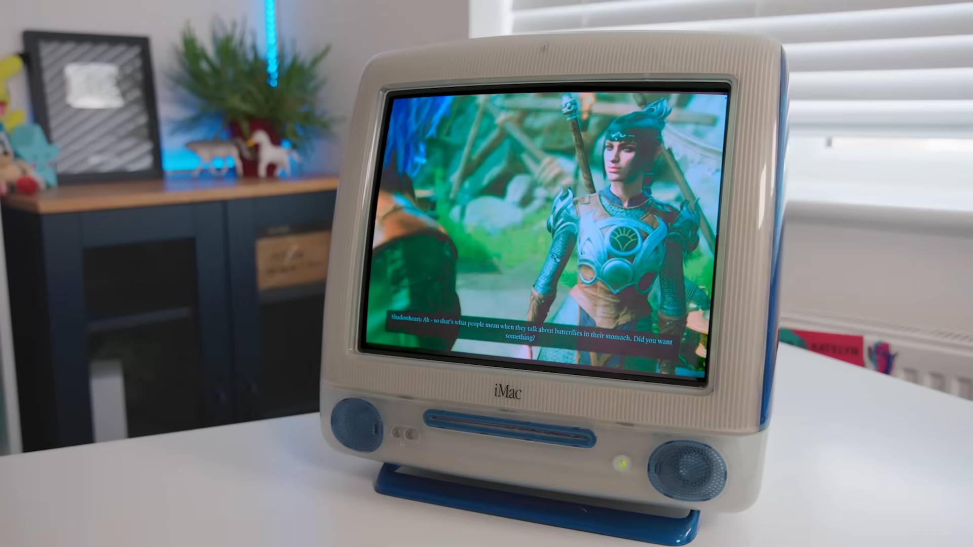 iMac G3 with Mac mini inside on white desk running Baldur's Gate 3.