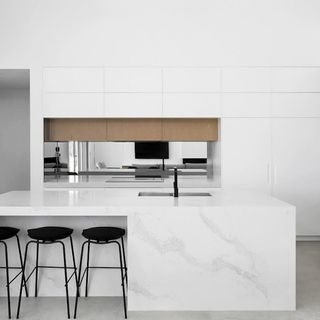 contemporary kitchen with white scheme and marble kitchen island by meir australia