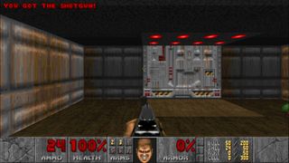 A screenshot of Doom, with DoomGuy's face grinning after picking up the shotgun