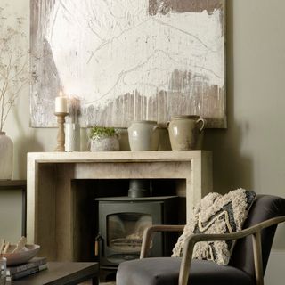 Image of a fireplace in a neutral living room with a large abstract canvas above the mantel