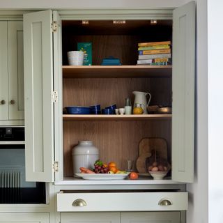 kitchen pantry with white cupboard with food items