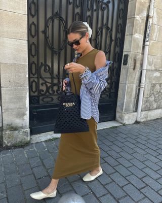 @annelauremais wearing striped button-down layered over an olive green dress