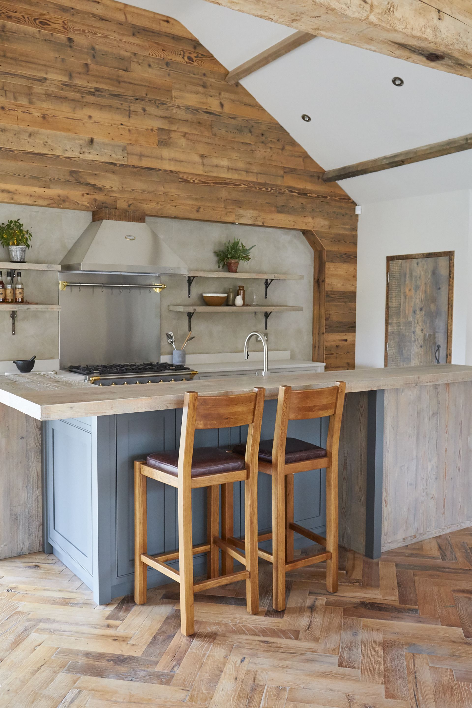 kitchen with blue island and wooden countertop and two chairs main company