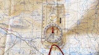 how to orientate a map: lining the orientating arrow up with the compass needle