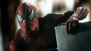 Spider-Man sits on a rooftop in Spider-Man