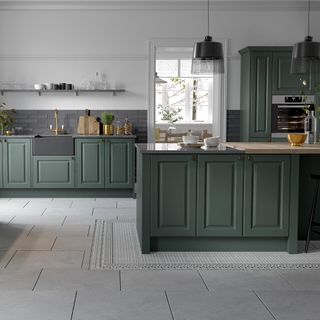 kitchen room with white wall and green cabinets with grey slate flooring