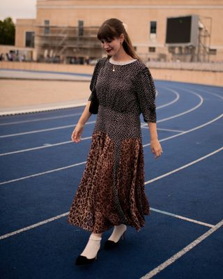 Senior fashion editor Halie LeSavage wears a mixed print Rixo dress and Manolo Blahnik heels as she walks the runway at the Baum und Pferdgarten show