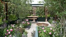 small garden design with path, planting, outdoor furniture and screening