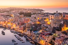 Procida Naples colorful island in the italian sea coast Sunset over La Corricella Harbour