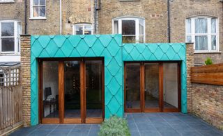 green copper tiles clad this London house extension