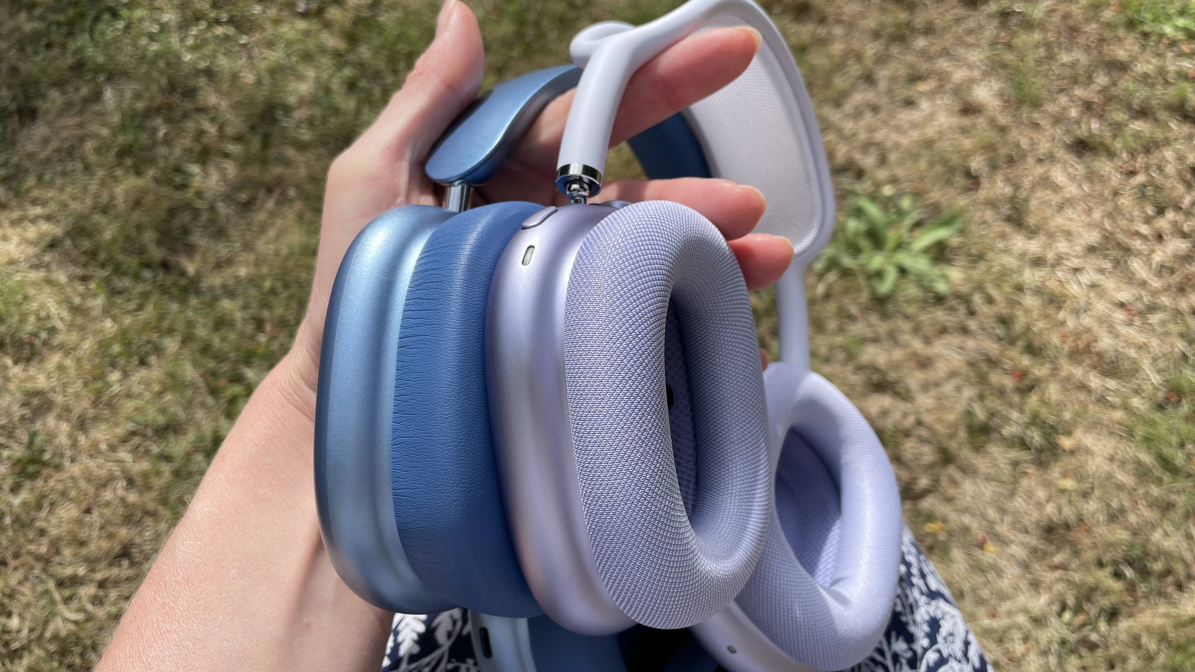 Wentronic YO1 (AirPods Max dupe) headphones in blue with AirPods Max nearby to compare and contrast their looks, outside on a sunny day