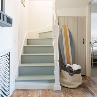 stair case with grey steps and wooden floor