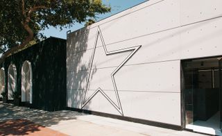 Golden goose deluxe brand Los Angeles headquarters exterior showing cement building wall with star