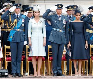 Prince William, Duke of Cambridge, Catherine, Duchess of Cambridge, Prince Harry, Duke of Sussex and Meghan, Duchess of Sussex attend a ceremony to mark the centenary of the Royal Air Force on the forecourt of Buckingham Palace on July 10, 2018