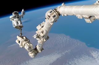 Astronaut Rides Canadarm2