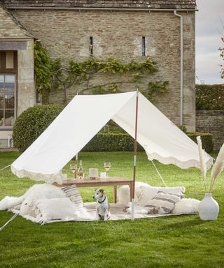 fringed canopy in white from cox & cox on lawn