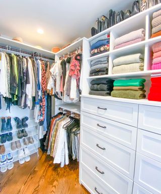 an organized white walk in wardrobe with small neat stacks of folded clothes and paired shoes