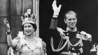Queen Elizabeth II and the Duke of Edinburgh wave at the crowds from the balcony at Buckingham Palace after Elizabeth's coronation