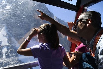 A file photo shows a family on a cable car above the French Alps.