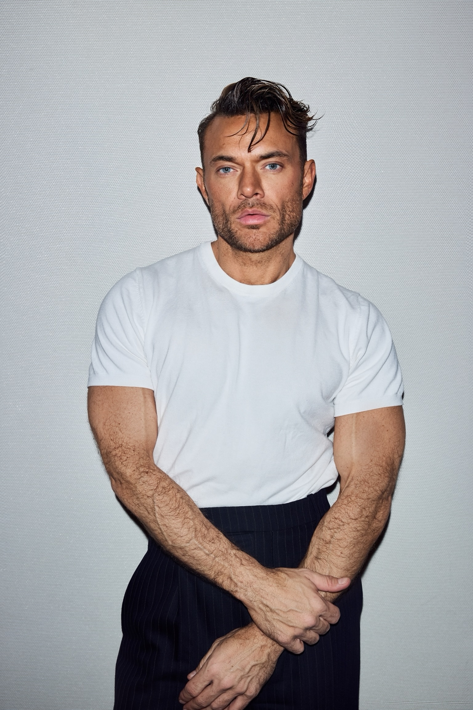 a white man in a white t-shirt and black pants