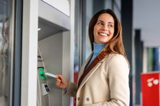 Woman Using ATM for banking services