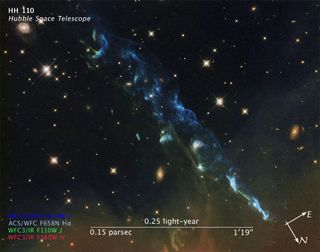Herbig-Haro 110 is a geyser of hot gas from a newborn star that splashes up against and ricochets from the dense core of a cloud of molecular hydrogen. This image was taken with Hubble's Advanced Camera for Surveys in 2004 and 2005 and the Wide Field Camera 3 in April 2011. Compass and scale added for reference.