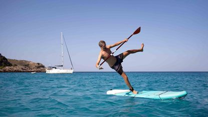 Man about to fall off paddleboard
