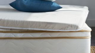 A closeup of the Saatva High-Density Foam mattress topper on a bed