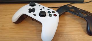 A GameSir G7 Xbox controller with a swappable faceplate sitting on a wooden desk