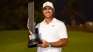 Brooks Koepka poses with the trophy after winning the LIV Golf Jeddah tournament