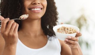 A close up of a woman eating Special K cereal whilst on the diet