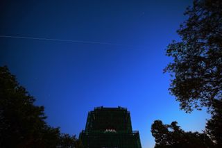 China's space station core module 'Tianhe' flies over the Bell Tower on May 2, 2021 in Beijing, China. 