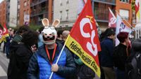 A protester wears a mask bearing the likeness of a "Raving Rabbids" Ubisoft video game character as employees demonstrate, launching a 3-day strike at the French video game headquarters Ubisoft in Saint-Mande, outside Paris, on October 15, 2024. Workers at video game giant Ubisoft began three days of strike action in France on October 15 in a dispute over home working and pay, hitting a firm already struggling with poor sales and a collapsing share price. The value of Ubisoft shares has collapsed by more than 40 percent since the beginning of the year, touching their lowest level in 10 years in September. This week's strike, caused by a September message from management insisting on a return to three days working in the office for all staff worldwide, follows on from another walkout in February when hundreds in France joined a dispute over pay. (Photo by Dimitar DILKOFF / AFP) (Photo by DIMITAR DILKOFF/AFP via Getty Images)