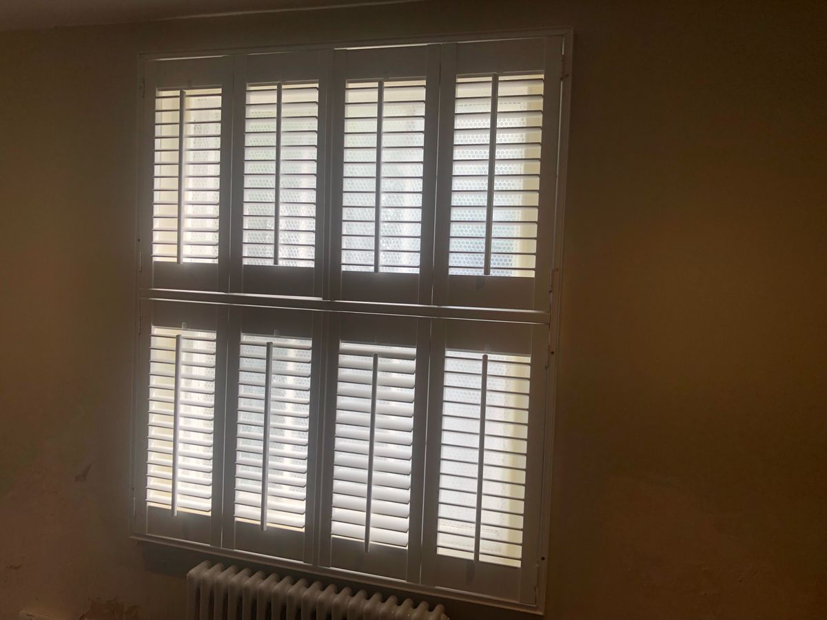 A bubble wrapped window with the blinds closed