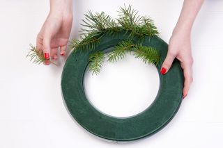Add foliage to your floral Christmas wreath