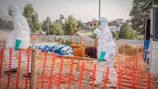 Health workers transport Ebola patient in Congo from ambulance