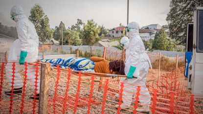 Health workers transport Ebola patient in Congo from ambulance