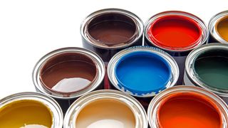 Open cans of different colours of paint.