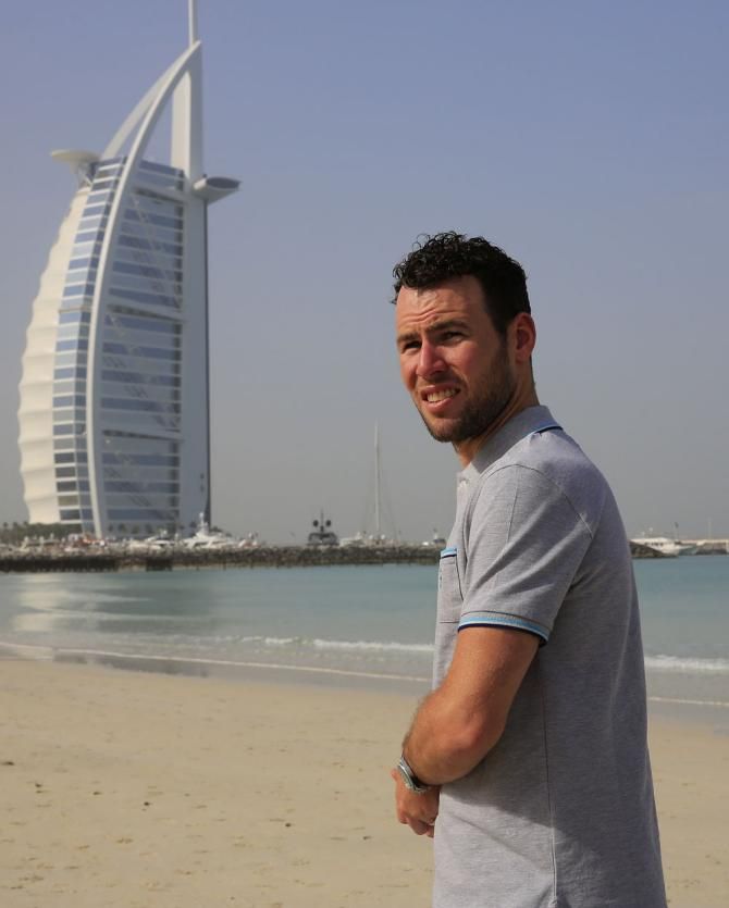 Mark Cavendish poses with the Dubai landscape in the background