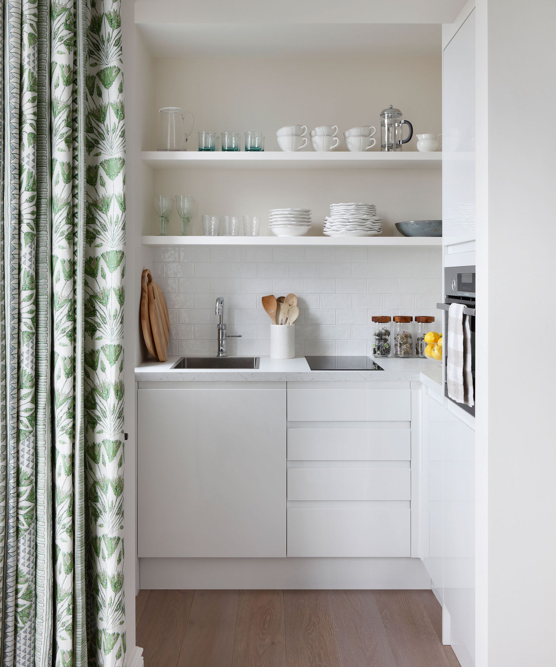 Small kitchen with white cabinets and u-shaped layout