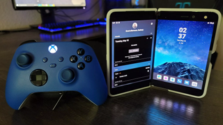 The Surface Duo next to an Xbox Wireless Controller.