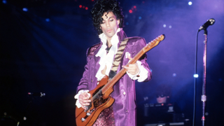 Prince performs onstage during the 1984 Purple Rain Tour on November 4, 1984