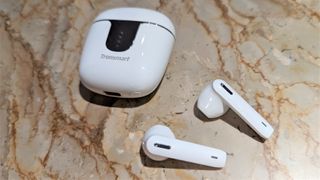 Tronsmart Onyx Ace Pro wireless earbuds and case on a marble table