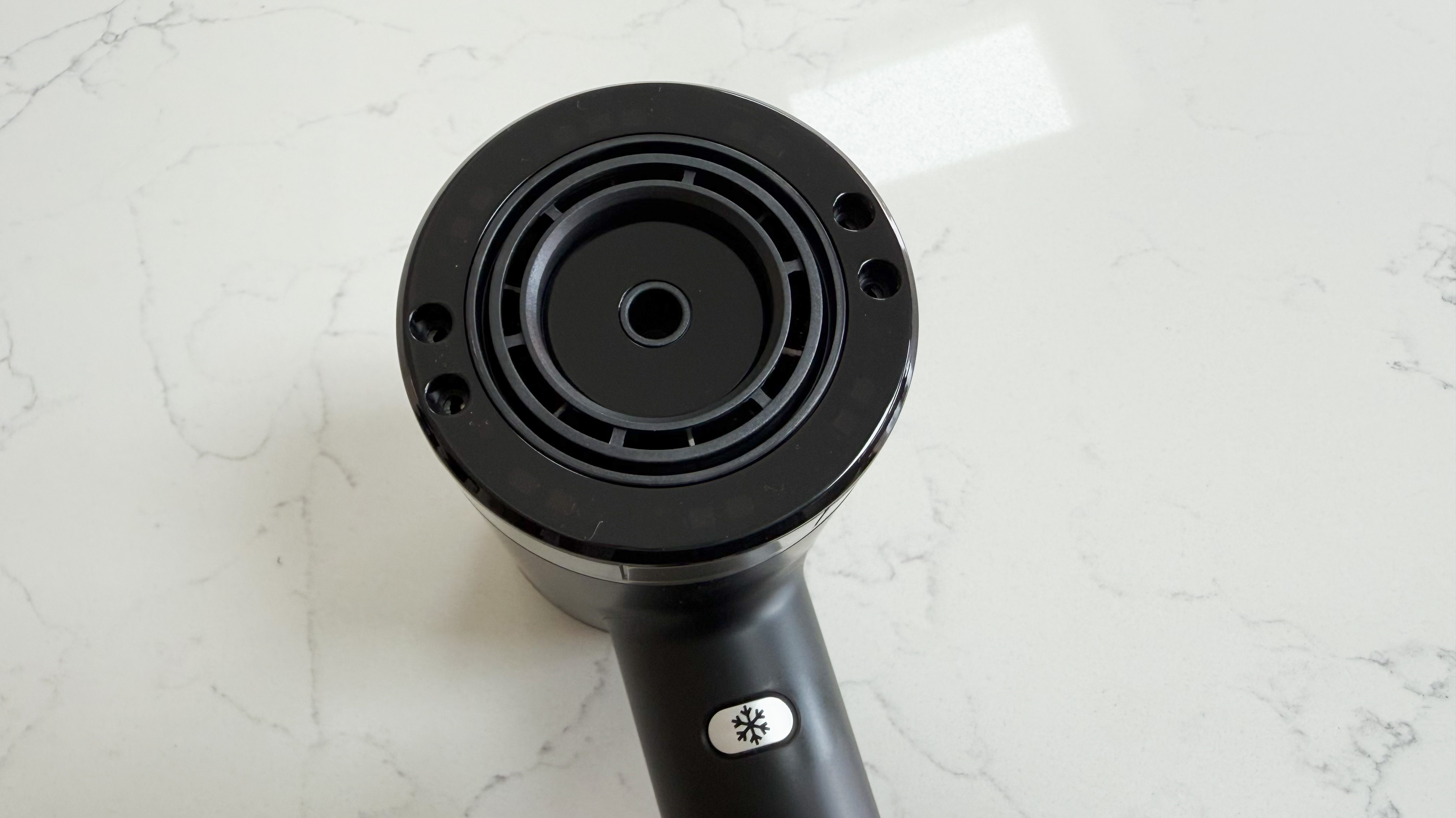 Close-up of the Revamp Tri-Care hair dryer barrel showing LED heat indicators and Cold shot button