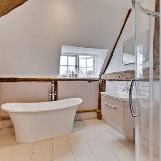 attic white bathroom with bathtub