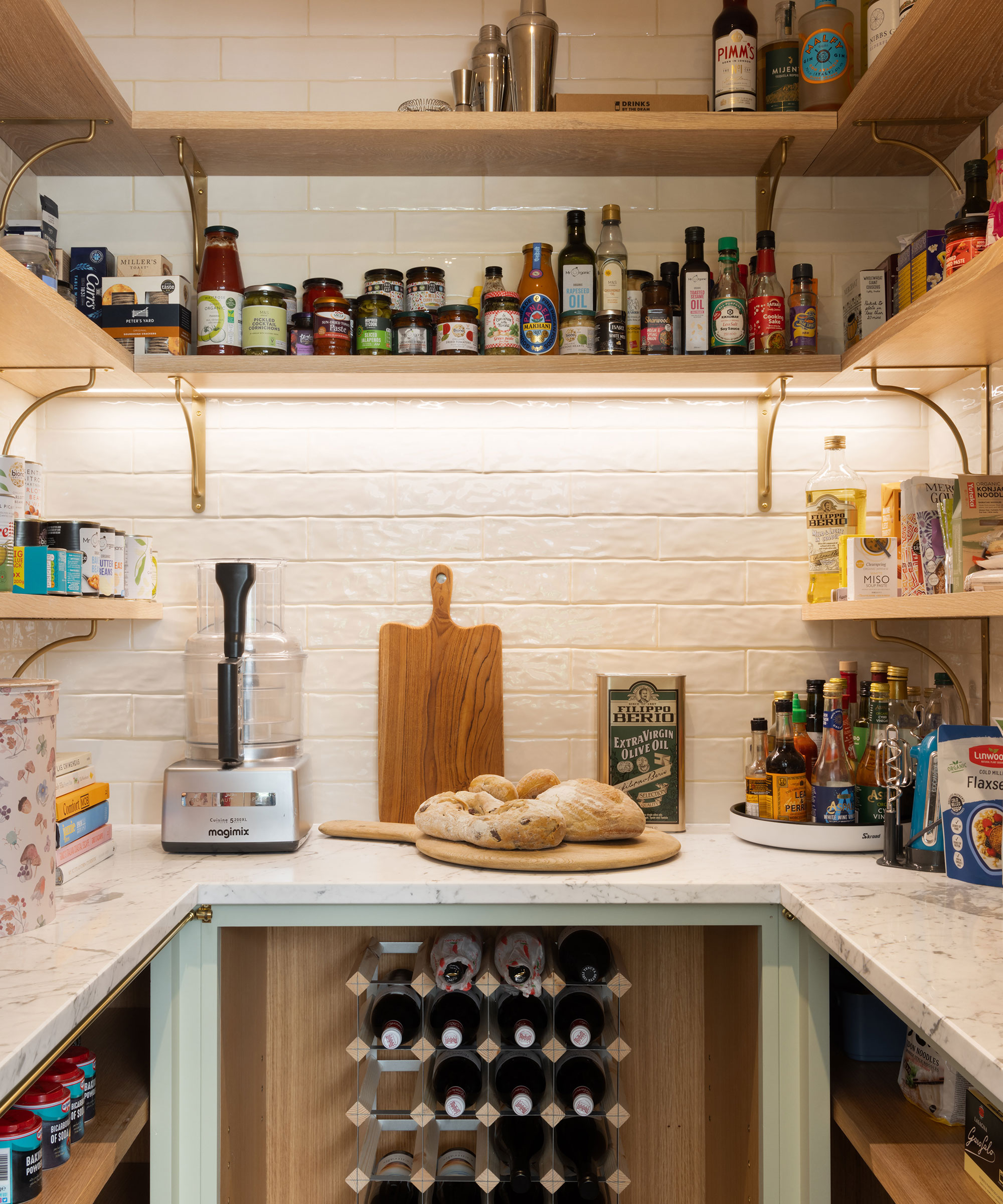 small pantry with wine rack and open shelving and marble worktop
